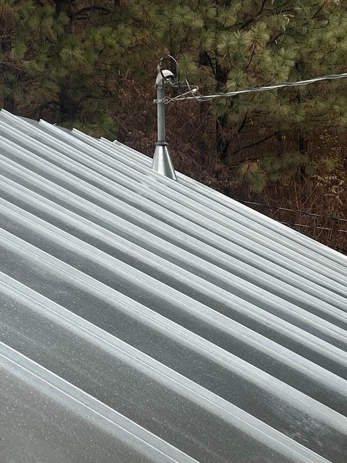Galvanized Standing Seam with a seamed in cone flashing.