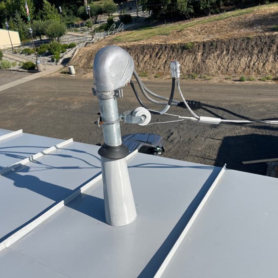 A electrical mast flashed using a folded cone.